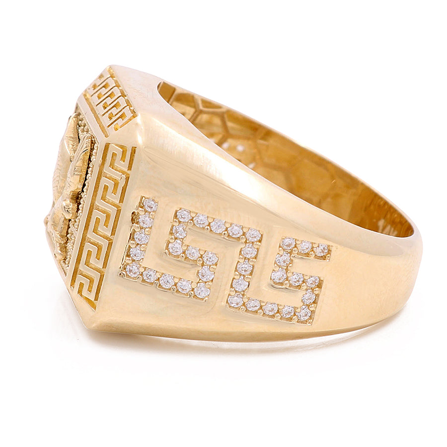 A Miral Jewelry 14K yellow gold eagle ring with cubic zirconias and a lion design on it.