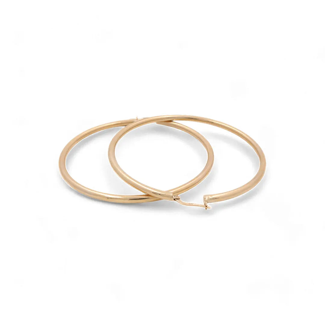 Two 14K Yellow Gold Large Hoop Women's Earrings by Miral Jewelry on a plain white background.