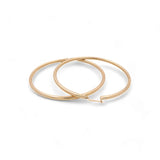 Two 14K Yellow Gold Large Hoop Women's Earrings by Miral Jewelry on a plain white background.