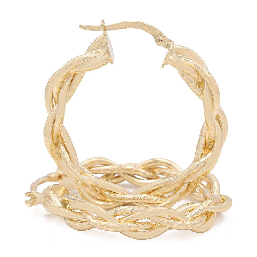 A pair of glamorous Miral Jewelry 14k Yellow Gold Twisted Hoop Earrings.
