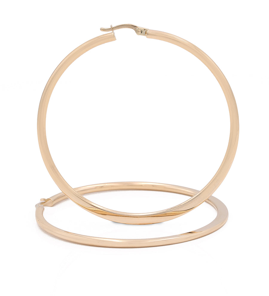 A pair of Miral Jewelry 14k Yellow Gold Large Hoop Earrings, showcasing elegance, on a white background.