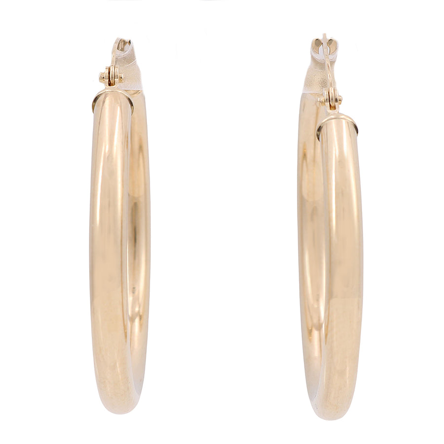 A classic pair of Miral Jewelry 10K Yellow Gold Hoop Earrings.