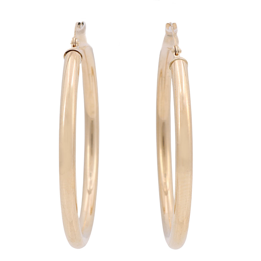 A pair of Miral Jewelry 10K Yellow Gold hoop earrings on a white background, perfect for your jewelry collection.