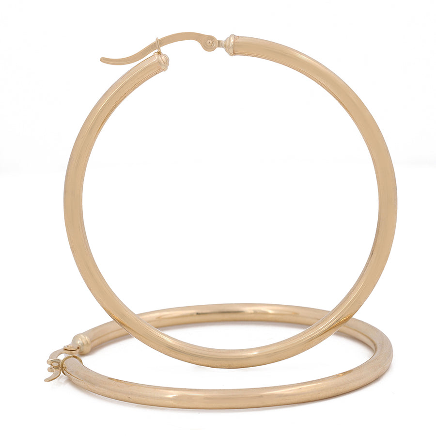 A pair of elegant Miral Jewelry 10K Yellow Gold Hoop Earrings on a white background.