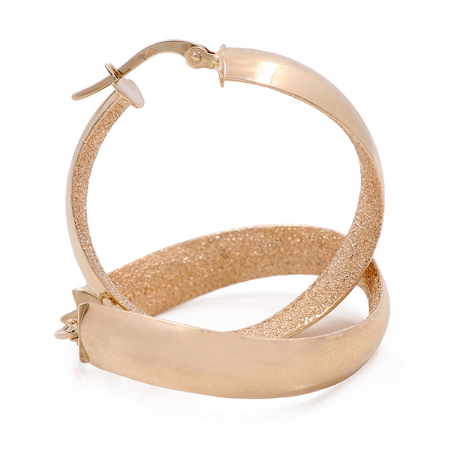 A pair of Miral Jewelry 14K yellow gold fashion hoop earrings with satin finish inside on a white background.