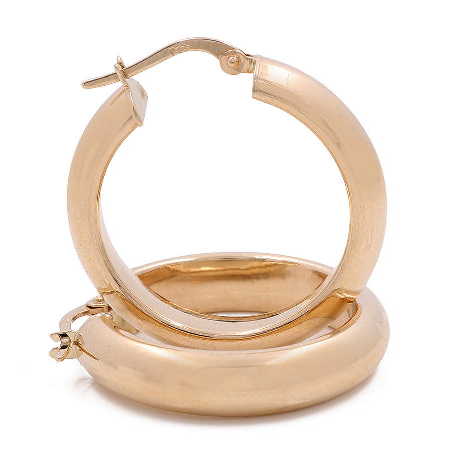 A pair of Miral Jewelry 14K Yellow Gold Fashion Hoop Earrings with a timeless style on a white background.