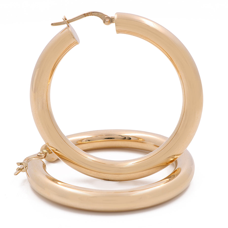A pair of Miral Jewelry's 14K Yellow Gold Fashion Hoop Earrings for the accessory game on a white background.