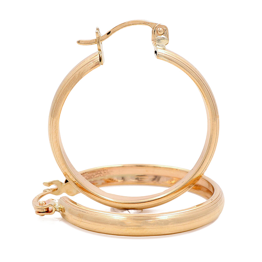 A pair of Miral Jewelry 10K Yellow Fashion Hoops Earrings on a white background.
