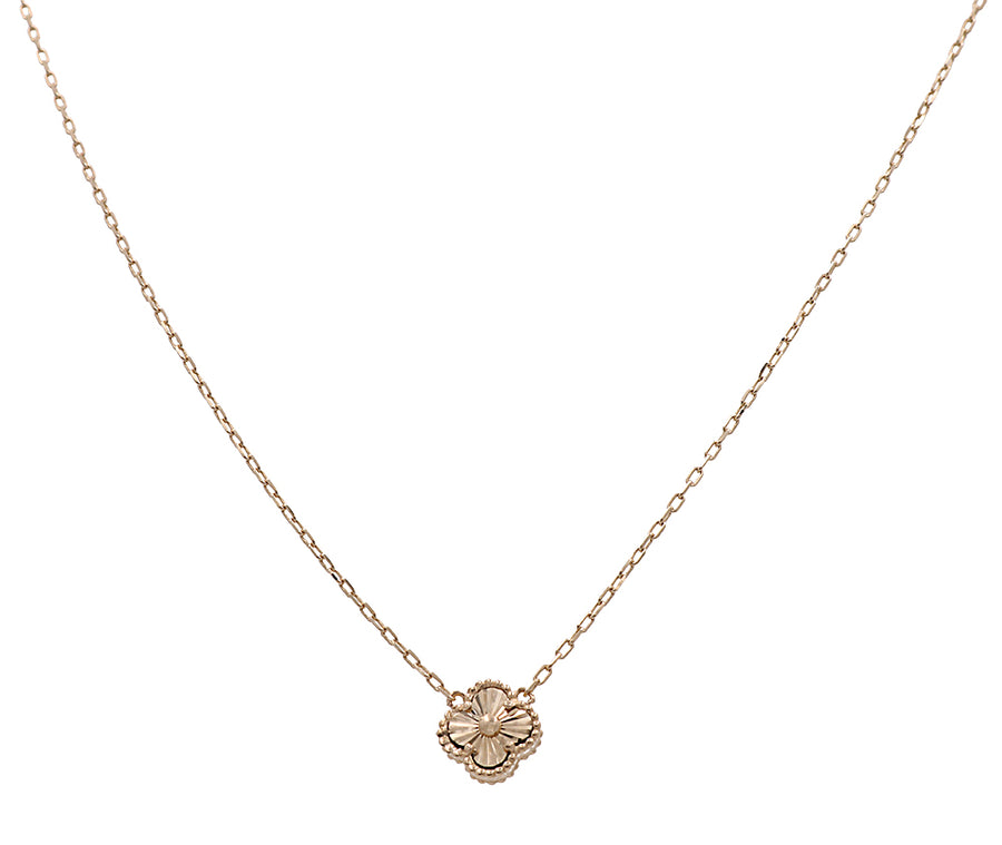 A Miral Jewelry 14K yellow gold necklace with a delicate flower pendant, perfect for the fashion-forward individual.