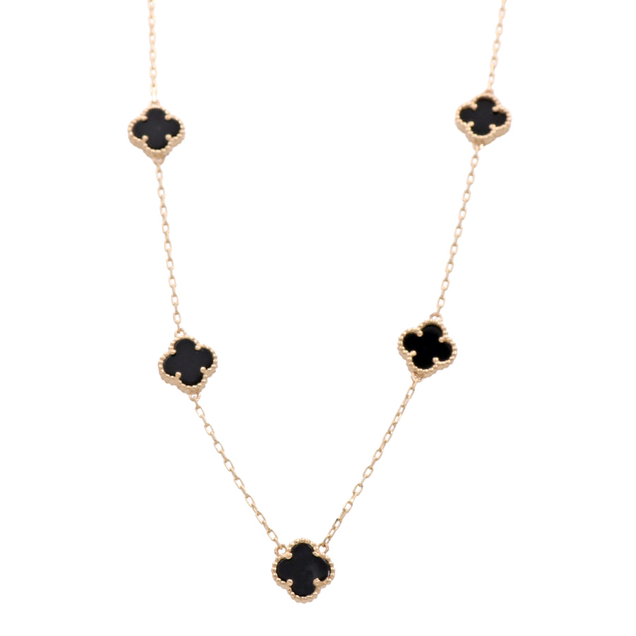 A Miral Jewelry 14K yellow gold necklace with four black clover pendants.