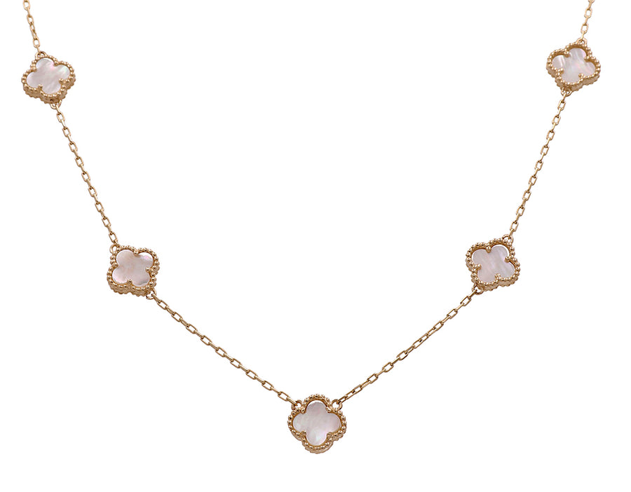 A necklace with white stones and a gold chain made of Miral Jewelry's 14k yellow gold.
