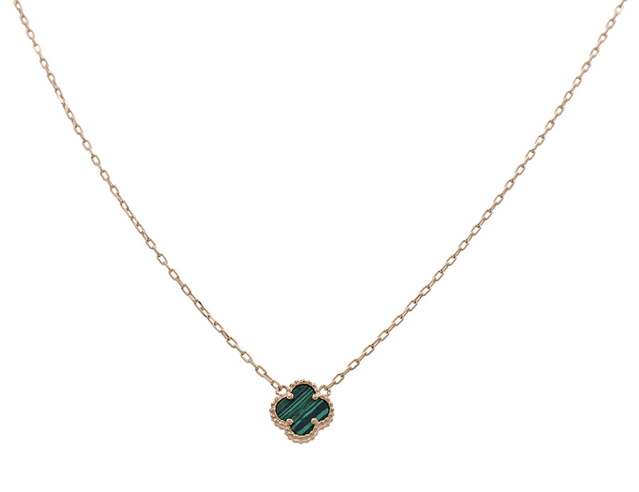 A 14K yellow gold necklace with a striking emerald green stone, sure to make you a fashion icon from Miral Jewelry.