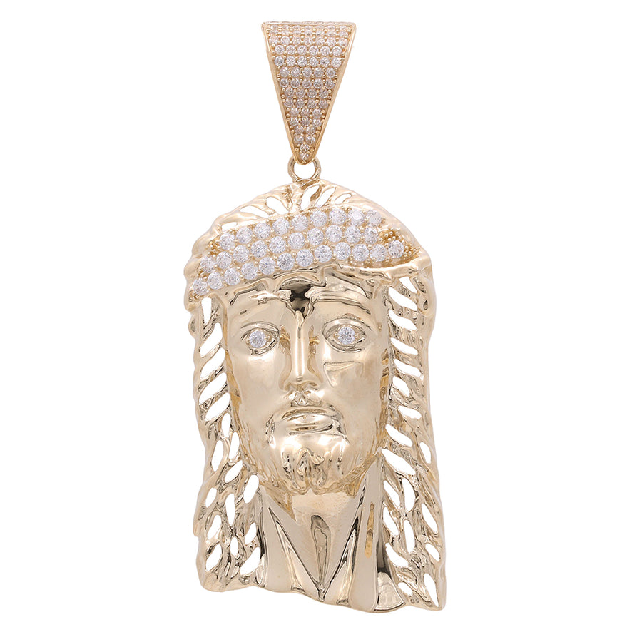 14K Yellow Gold Jesus Head Pendant with Cubic Zirconias depicting a stylized face with diamond-encrusted crown and features, suspended from a diamond-studded bail by Miral Jewelry.