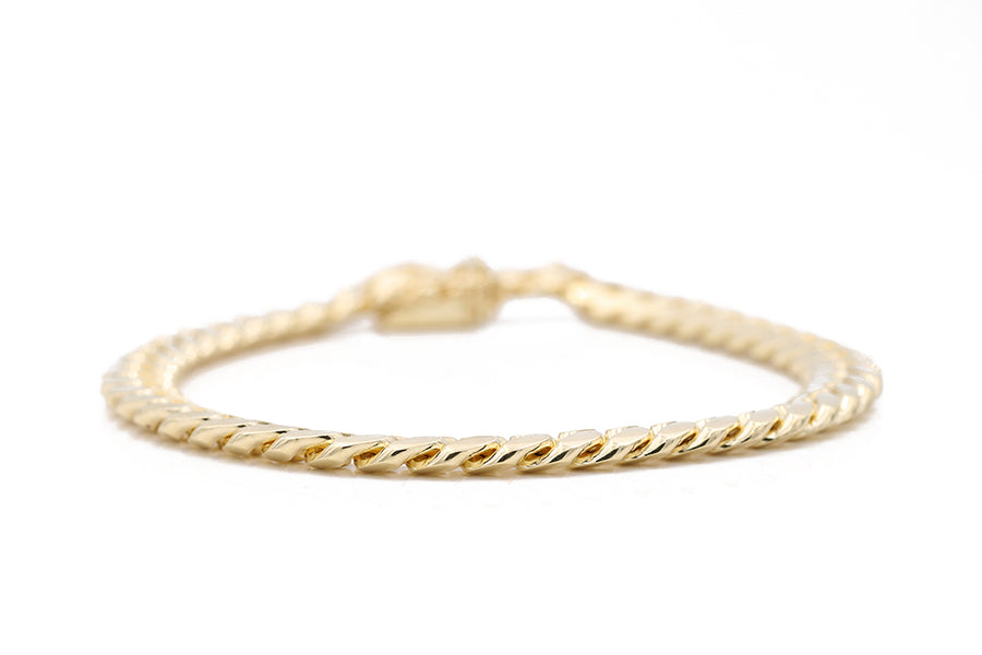 A Men's Miral Jewelry Yellow Gold 14K Cuban Link Bracelet with a twist clasp.
