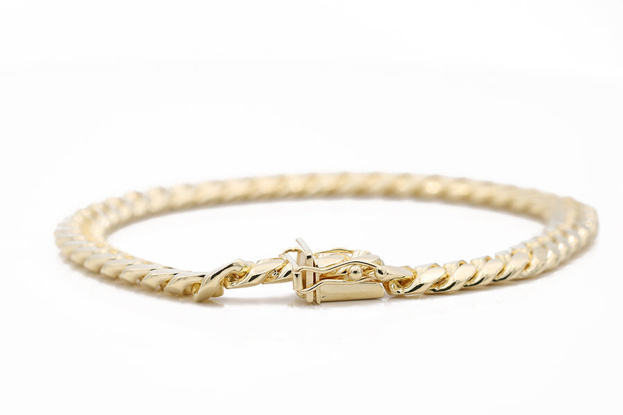 A Men's Yellow Gold 14K Cuban Link Bracelet from Miral Jewelry with a clasp.