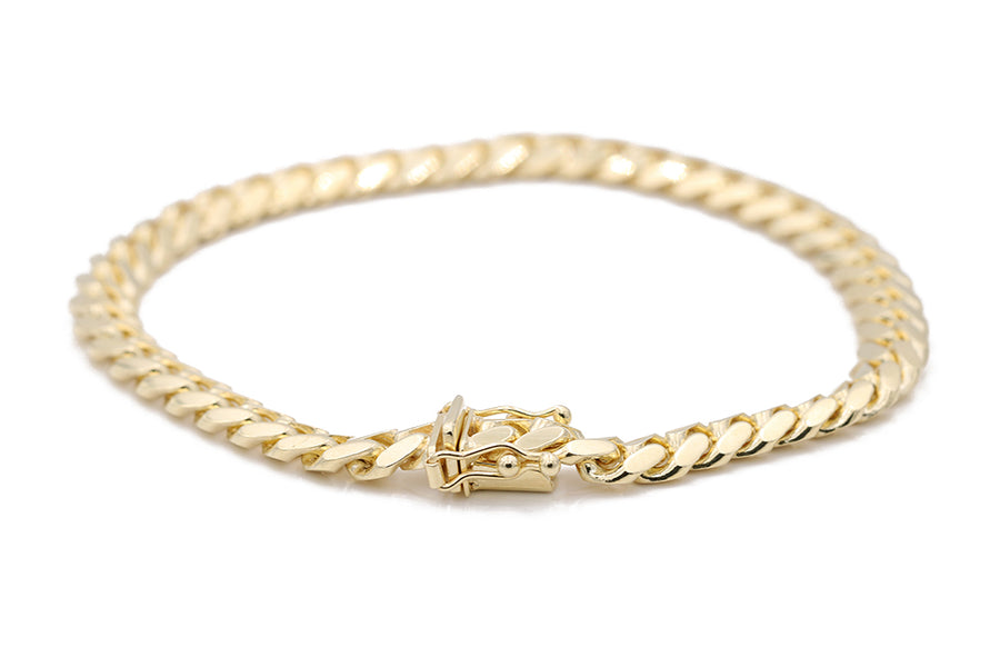 A Men's Yellow Gold 14K Cuban Link Bracelet from Miral Jewelry with a clasp.
