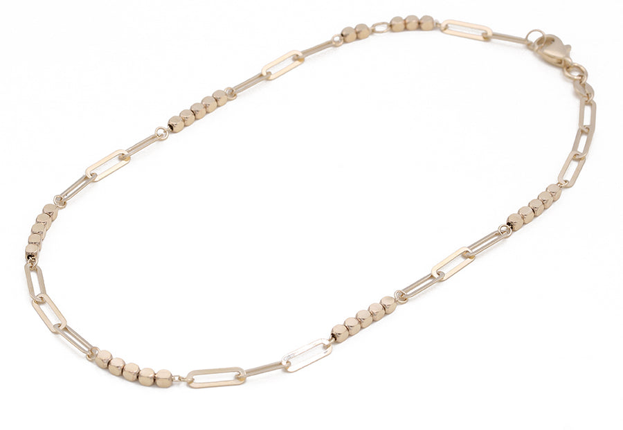 A Miral Jewelry 14K Yellow Gold Beads and Links Ankle Bracelet with two links.