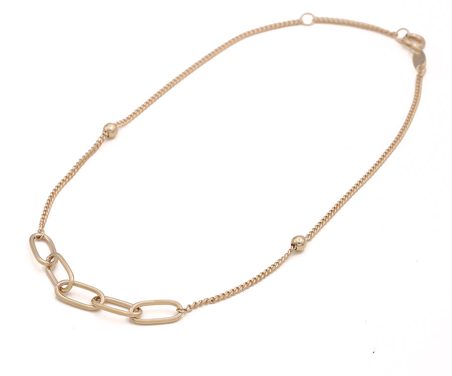 A Miral Jewelry 14K yellow gold chain necklace with a small link ankle bracelet.