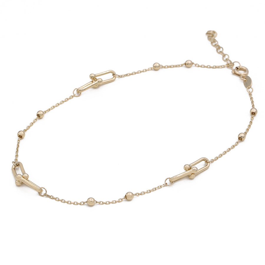 A Miral Jewelry 14K Yellow Gold Beads and Links Ankle Bracelet with chain links and beads.