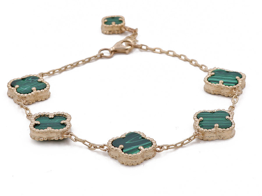 A bracelet crafted from Miral Jewelry's 14K Yellow Gold Fashion Flower Women's Green Stones Bracelet featuring vibrant green agate stones.