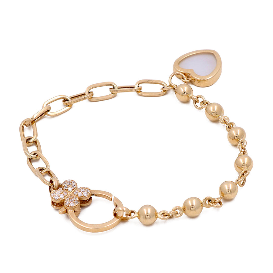 A Miral Jewelry 14K yellow gold-plated bracelet with a heart shaped charm.
