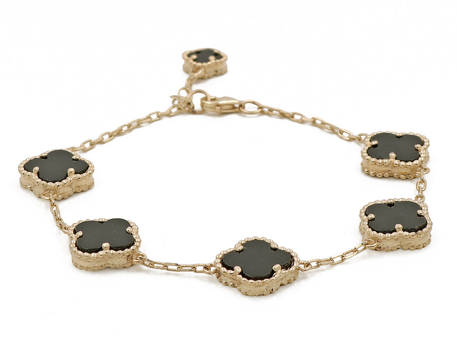 A Miral Jewelry 14K Yellow Gold Fashion Flower Women's Black Onyx Bracelet with black onyx stones.