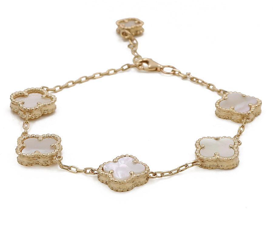 A Miral Jewelry 14K yellow gold-plated fashion bracelet with white mother of pearl flowers.