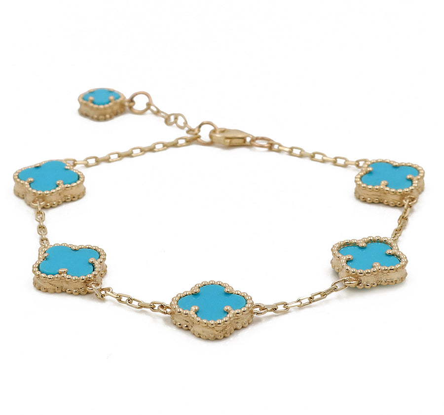 A Miral Jewelry 14K yellow gold bracelet adorned with turquoise stones.