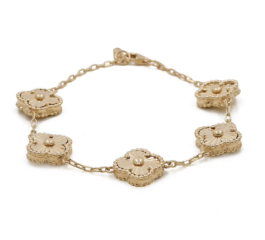 A Miral Jewelry 14K yellow gold bracelet with a fashion flower.