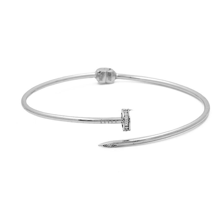 Miral Jewelry's 14K White Gold Fashion Nail Bracelet with Cubic Zirconias with a nail-shaped design and a small diamond accent near the head on a white background.
