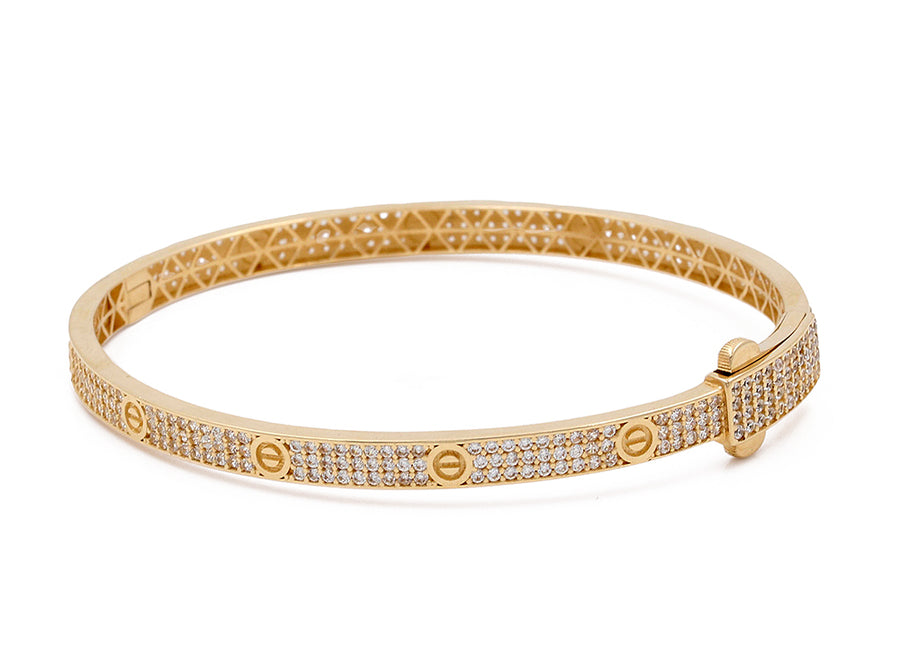 Miral Jewelry's 14K Yellow Gold Fashion Bracelet with Cubic Zirconias, featuring geometric cut-out patterns and a hinge closure, isolated on a white background.