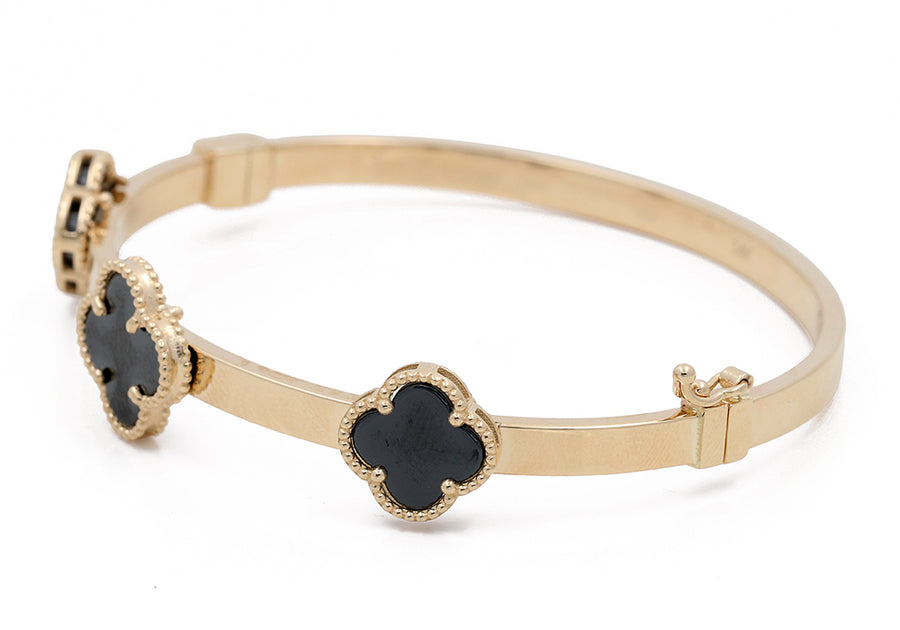 Miral Jewelry's 14K Yellow Gold Fashion with Onyx Flowers bracelet, featuring black heart-shaped stones set with intricate borders, is displayed on a white background.