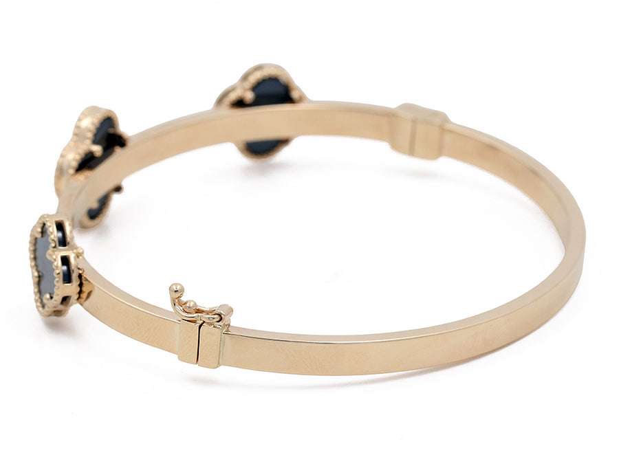 Miral Jewelry's 14K Yellow Gold Fashion with Onyx Flowers Bracelet, isolated on a white background.