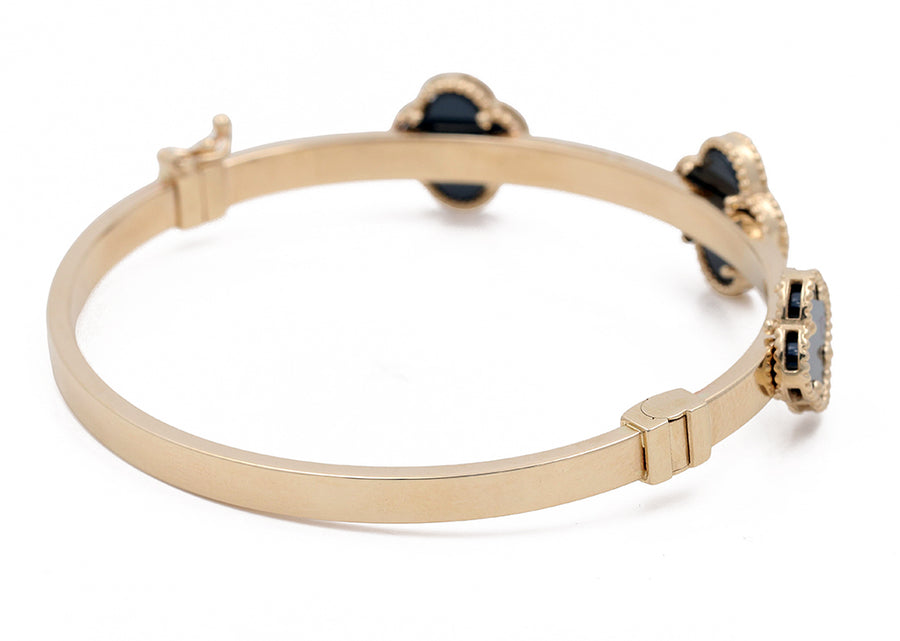 Miral Jewelry's 14K Yellow Gold Fashion with Onyx Flowers Bracelet features three onyx flowers, each set in an intricate mount, against a white background.