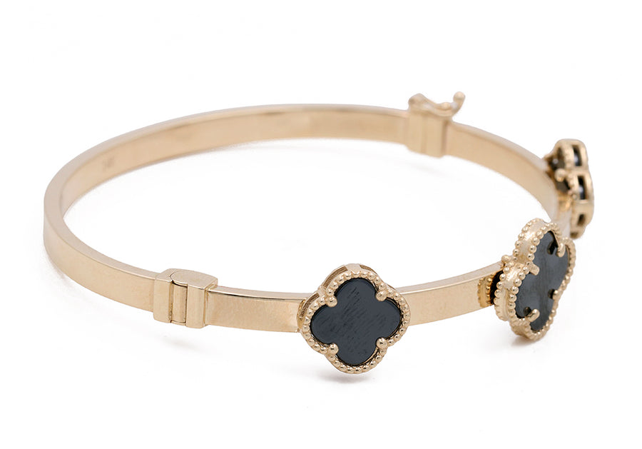 Miral Jewelry's 14K Yellow Gold Fashion with Onyx Flowers Bracelet, featuring three clover-shaped charms with scalloped edges, is displayed on a white background.