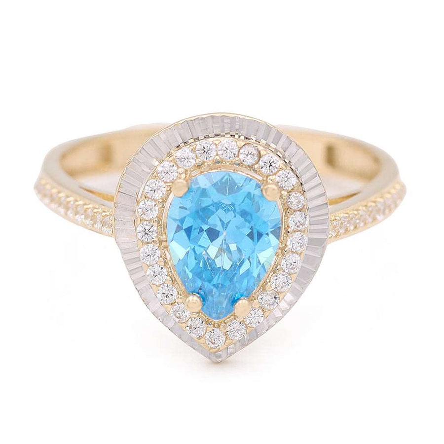 A 14K Yellow Gold Fashion Ring with Blue Tear Drop Center Stone and Cubic Zirconias in the Miral Jewelry brand.