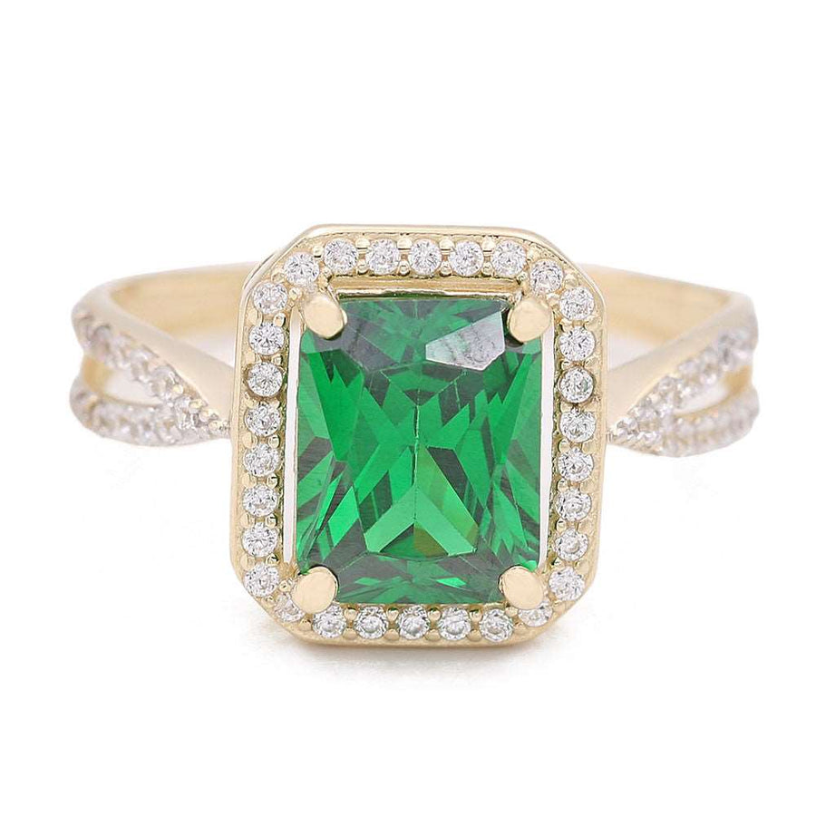 A stunning 14K Yellow Gold Fashion Ring with Green Center Stone and Cubic Zirconias, featuring a radiant green center stone by Miral Jewelry.