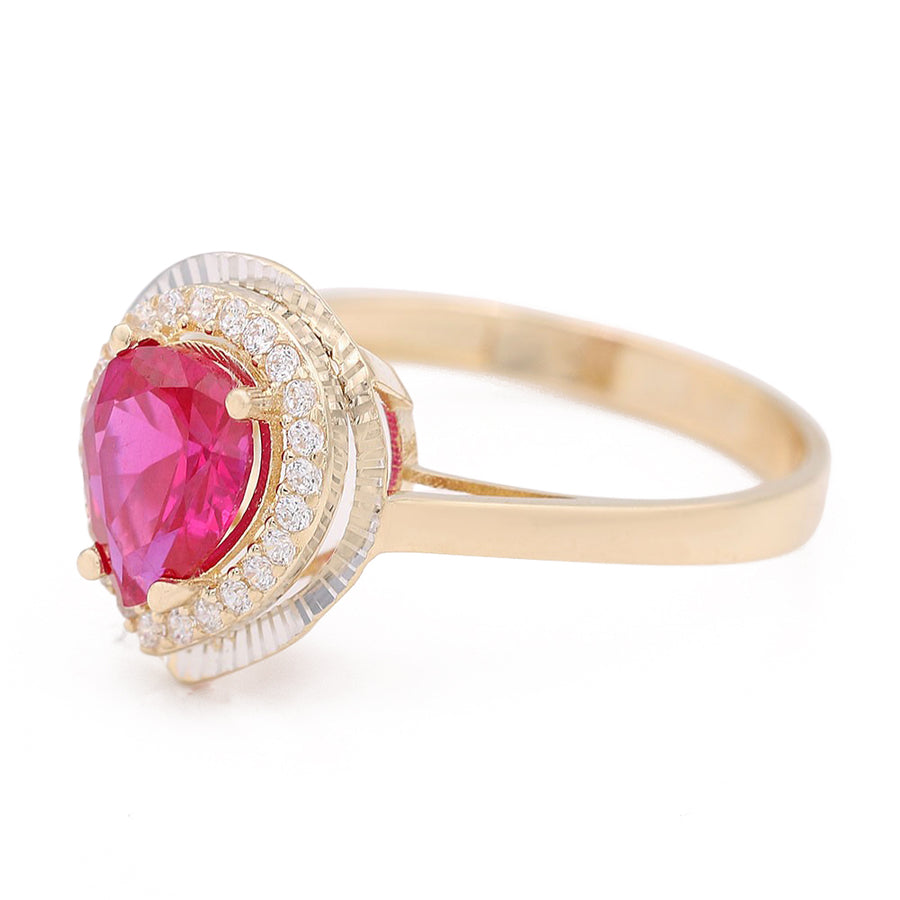 A Miral Jewelry pink sapphire and diamond fashion ring in 14K yellow gold with a tear drop center stone.