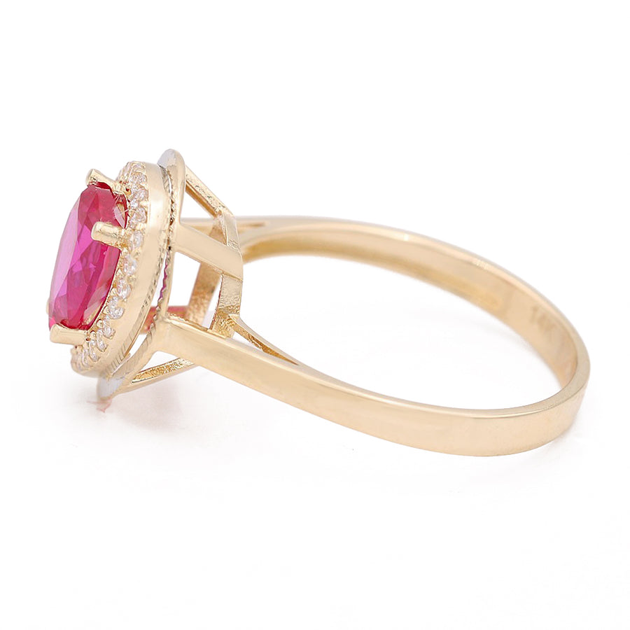 A Miral Jewelry 14K Yellow Gold Fashion Ring with Pink Tear Drop Center Stone and Cubic Zirconias.