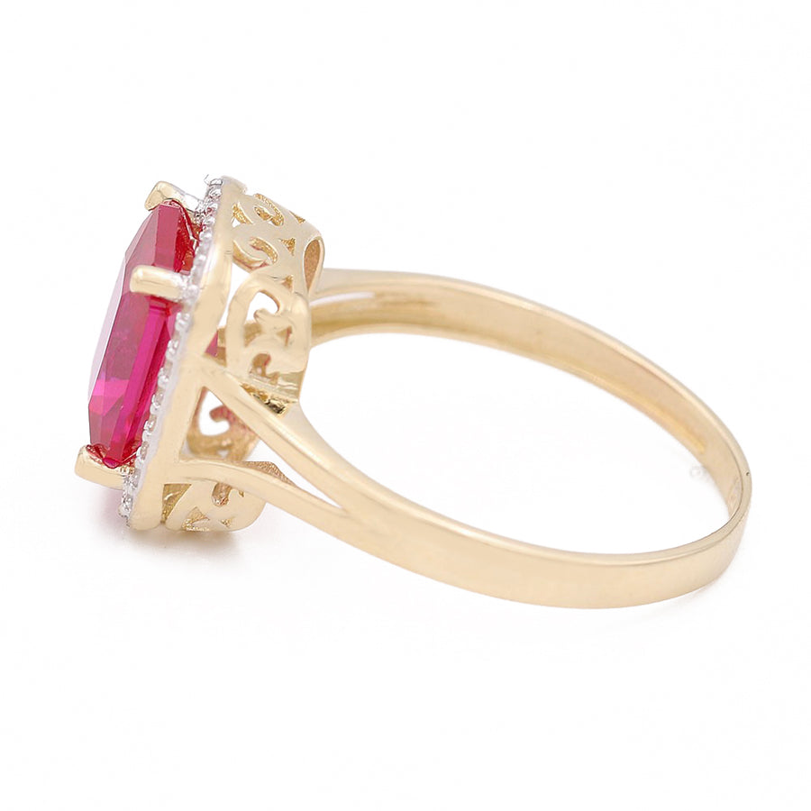 A stunning oval ruby and diamond ring set in Miral Jewelry's 14K Yellow Gold Fashion Ring with Pink Square Center Stone and Cubic Zirconias.