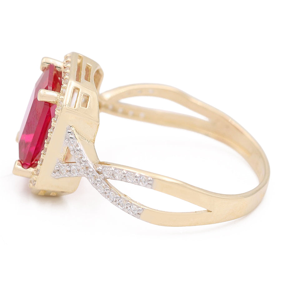 A Miral Jewelry 14K Yellow Gold Fashion Ring with Pink Center Stone and Cubic Zirconias surrounded by diamonds.