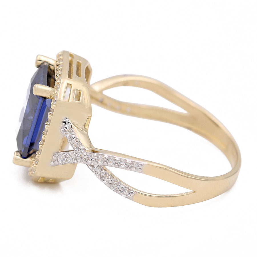 A Miral Jewelry 14K Yellow Gold Fashion Ring with Blue Square Center Stone and Cubic Zirconias, featuring diamond accents.