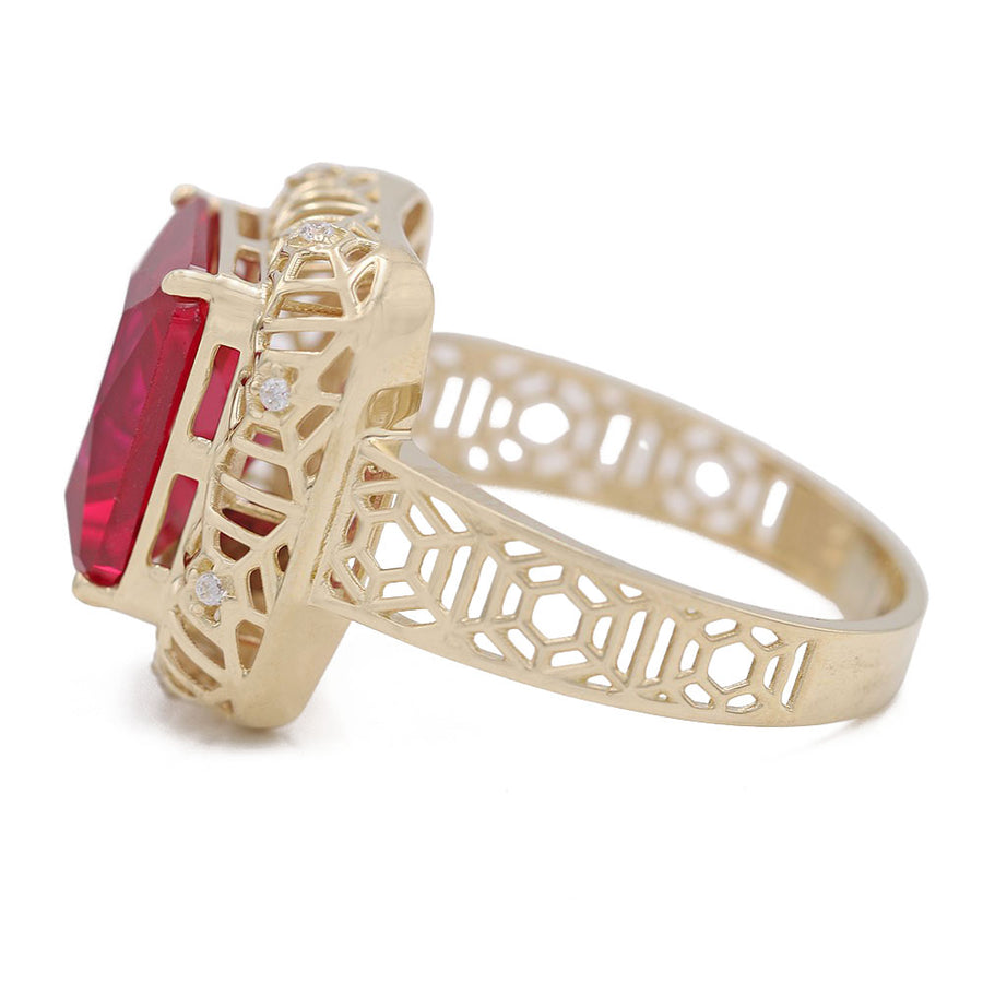 A Miral Jewelry 14K Yellow Gold Fashion Ring with Red Center Stone and Cubic Zirconias, surrounded by diamonds.