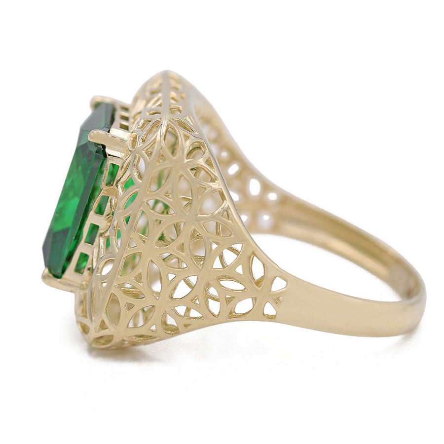 A Miral Jewelry 14K Yellow Gold Fashion Ring with Green Center Stone and Cubic Zirconias.