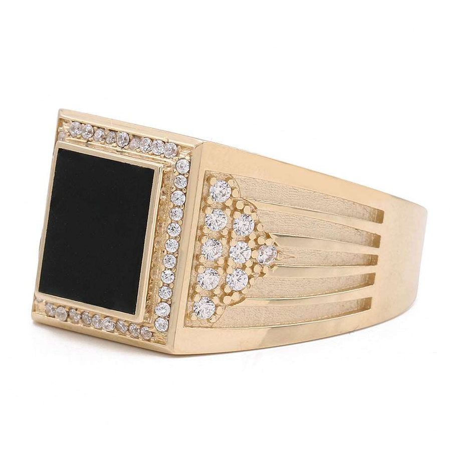 A Miral Jewelry 14K Yellow Gold Fashion Ring adorned with a sleek black onyx stone and shimmering diamonds.