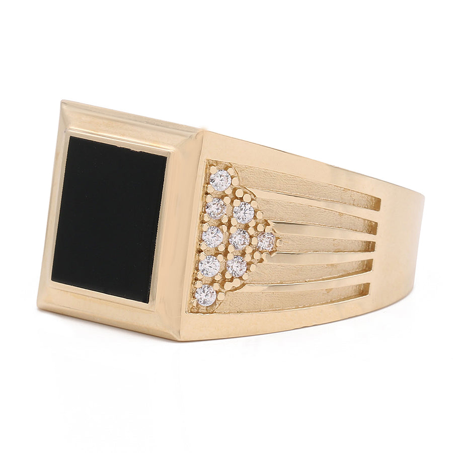 A Miral Jewelry 14K Yellow Gold Fashion Ring adorned with black color center stone and cubic zirconias.