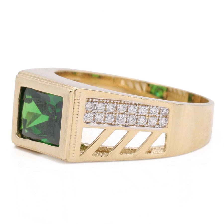 A Miral Jewelry yellow gold ring with a green tourmaline and diamonds. Made of 14K Yellow Gold, this fashion ring features a stunning green tourmaline stone surrounded by sparkling diamonds.
