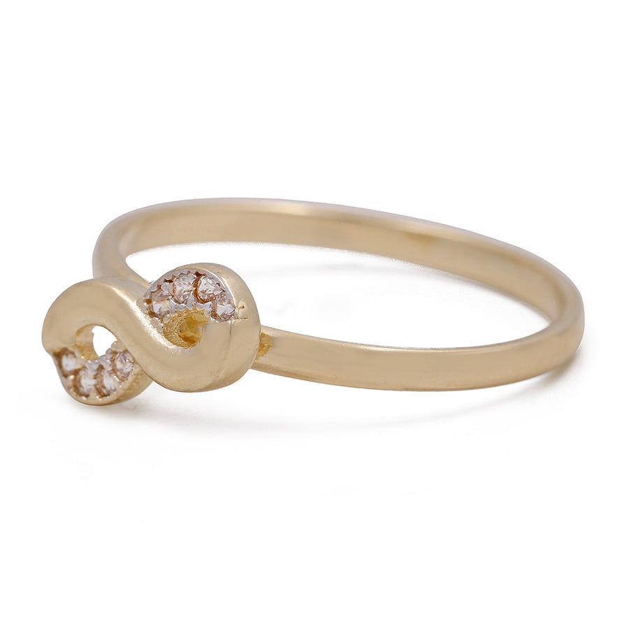 A Miral Jewelry 14K Yellow Gold Fashion Infinity Ring with Cubic Zirconias and diamonds.