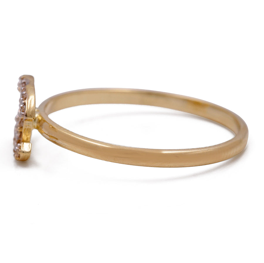 A 14K Yellow Gold Fashion Ring with Cubic Zirconias from Miral Jewelry with a diamond in the center.