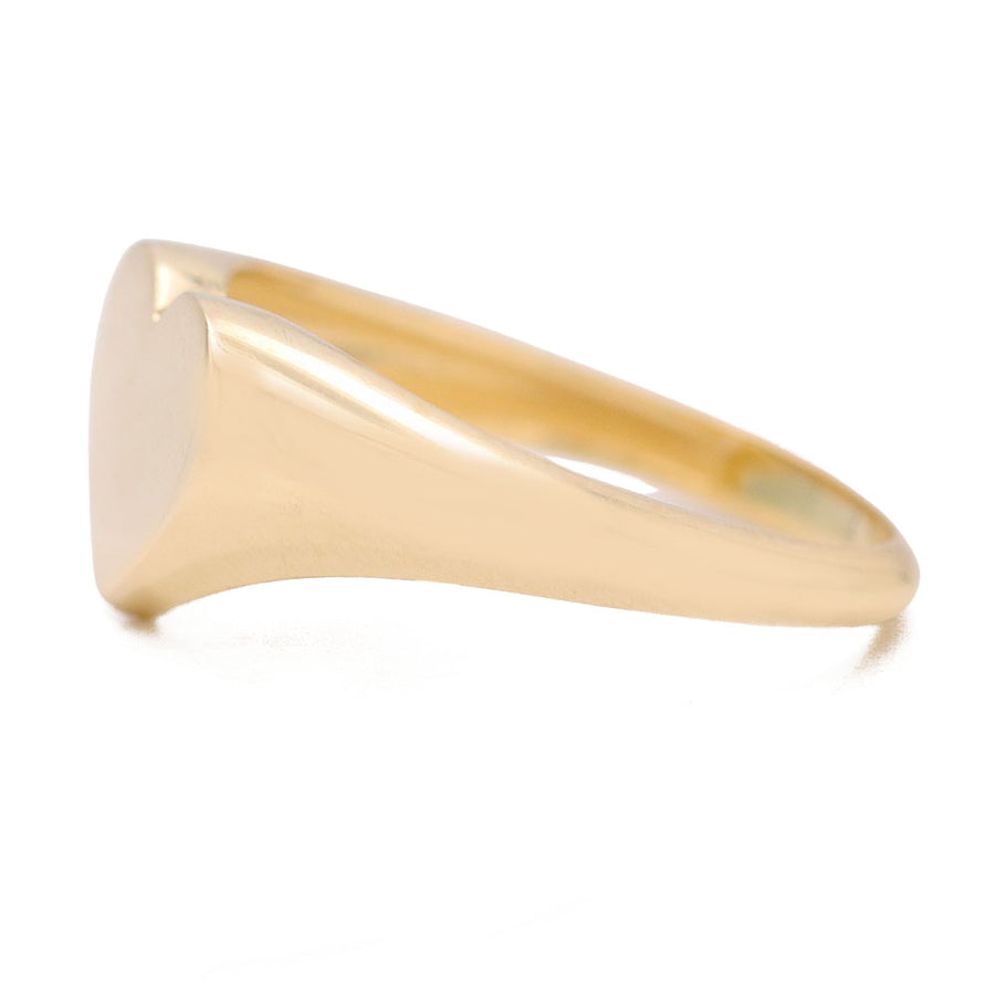 A fashion-forward Miral Jewelry 14K yellow gold heart shape ring on a white background.